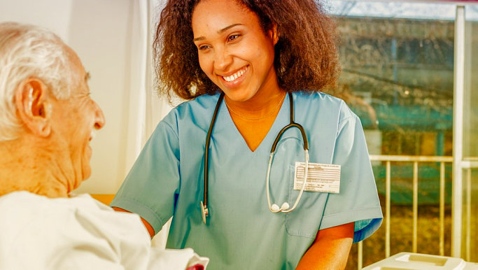 smiling nurse visiting senior man